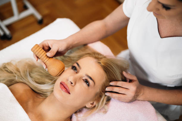 Aesthetic facial massage treatment with a wooden sculpting tool at Body Roll Spa